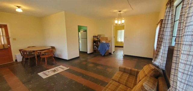 dining room with baseboards and a notable chandelier