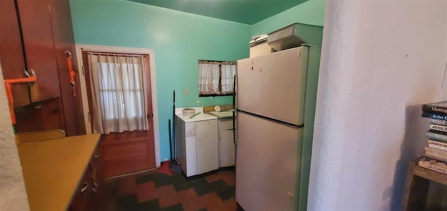 kitchen with washer / dryer and freestanding refrigerator