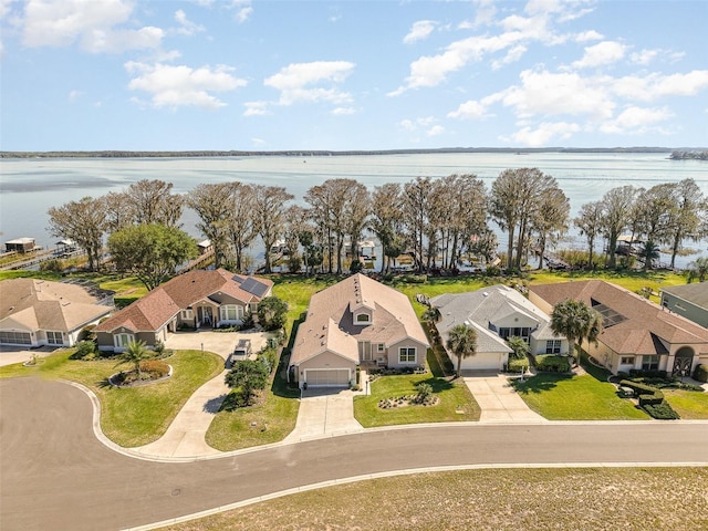 drone / aerial view with a residential view and a water view