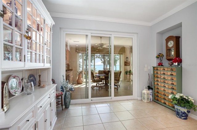 doorway with ornamental molding, a healthy amount of sunlight, and light tile patterned floors