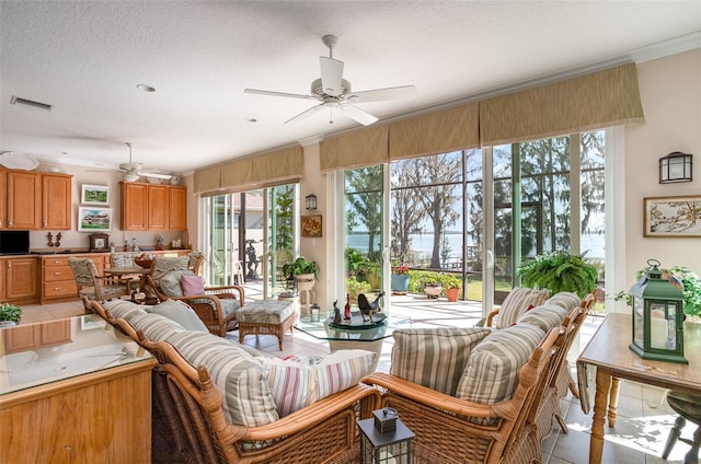 sunroom featuring ceiling fan and visible vents