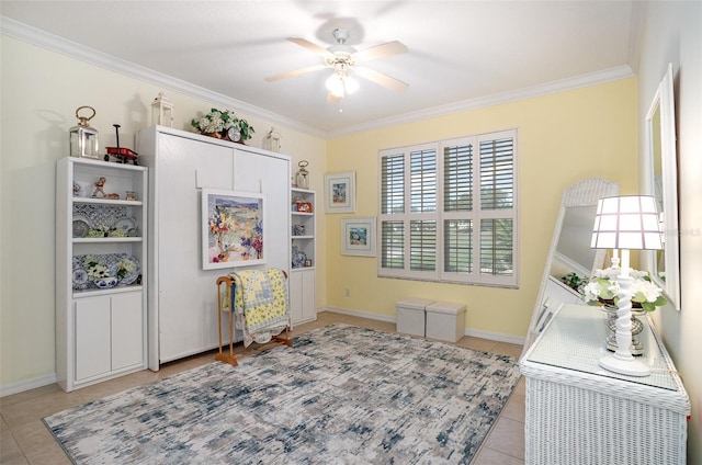 interior space featuring light tile patterned floors, baseboards, a ceiling fan, and crown molding