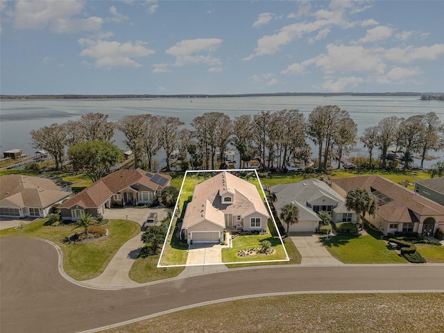 bird's eye view with a water view and a residential view