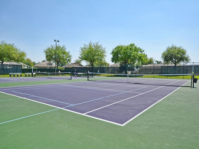 view of sport court featuring fence