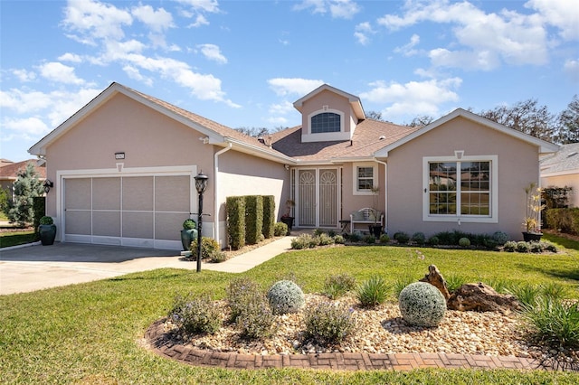 view of front of property featuring a front yard, concrete driveway, an attached garage, and stucco siding