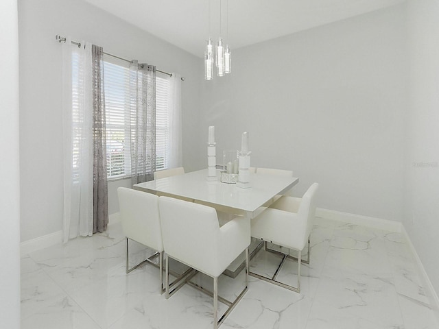 dining room featuring marble finish floor and baseboards