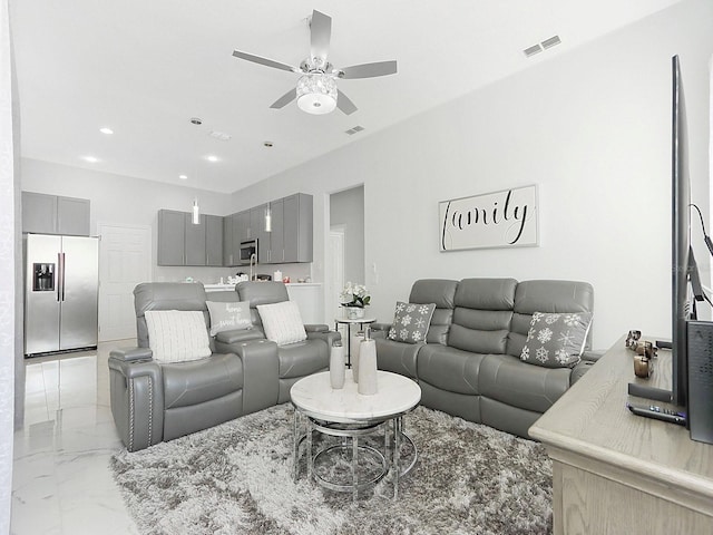 living room with marble finish floor, visible vents, a ceiling fan, and recessed lighting