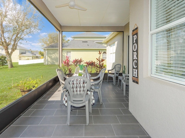 sunroom / solarium with a ceiling fan