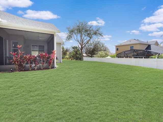 view of yard featuring a sunroom and fence