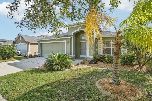 view of front facade featuring a garage, driveway, and stucco siding