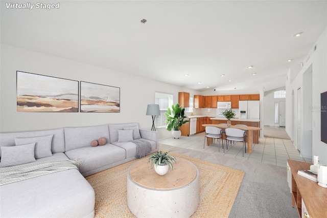 living area with vaulted ceiling, light tile patterned flooring, and recessed lighting