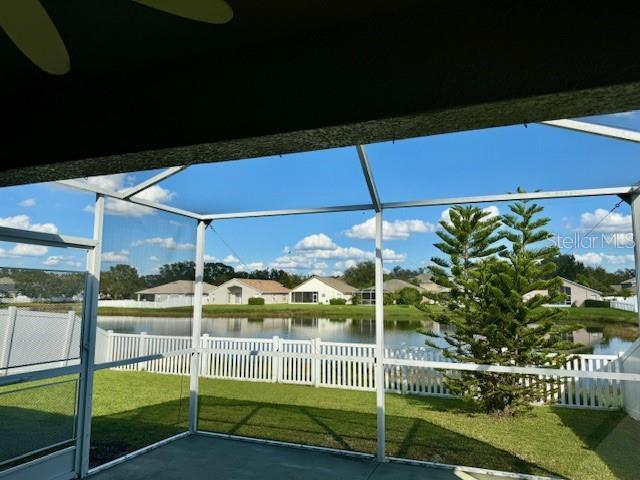 unfurnished sunroom featuring a water view