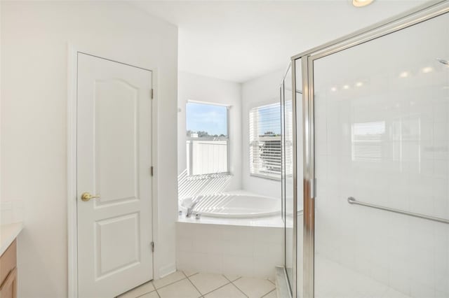 bathroom with a shower stall, vanity, and a bath