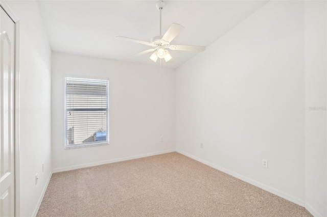 unfurnished room with ceiling fan, baseboards, and carpet flooring