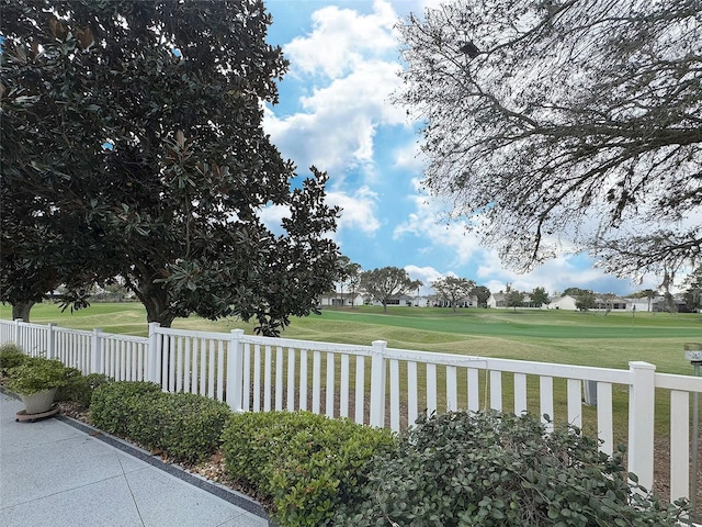 exterior space featuring fence and golf course view