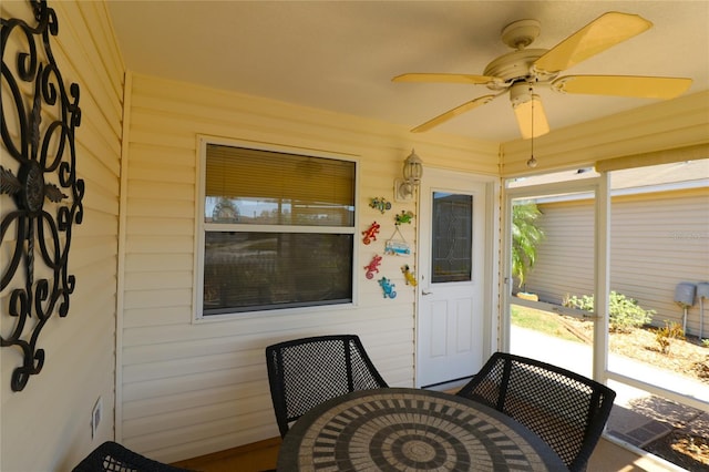 entrance to property featuring ceiling fan and outdoor dining space