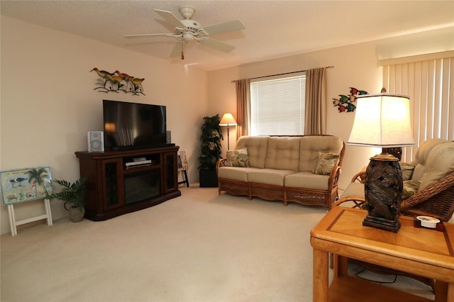 living area with light carpet and a ceiling fan