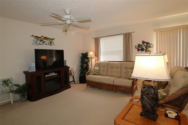 carpeted living room with ceiling fan and a textured ceiling