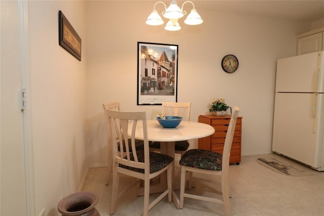 dining space featuring baseboards and an inviting chandelier