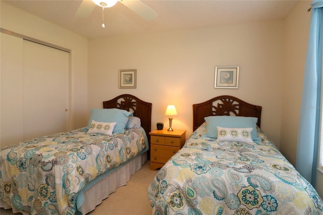 carpeted bedroom featuring a ceiling fan and a closet