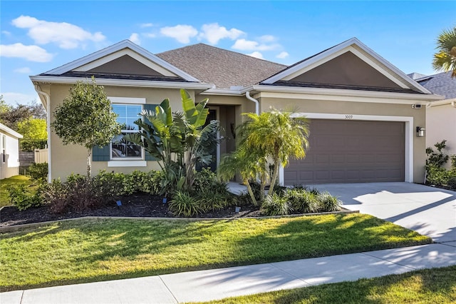 ranch-style home featuring a garage, concrete driveway, a front yard, and stucco siding