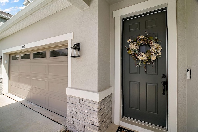 entrance to property with stucco siding