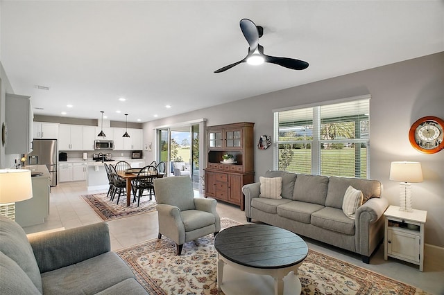 living room featuring light tile patterned floors, visible vents, a ceiling fan, and recessed lighting