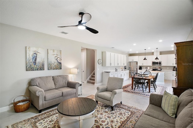 living room featuring recessed lighting, visible vents, stairway, and baseboards