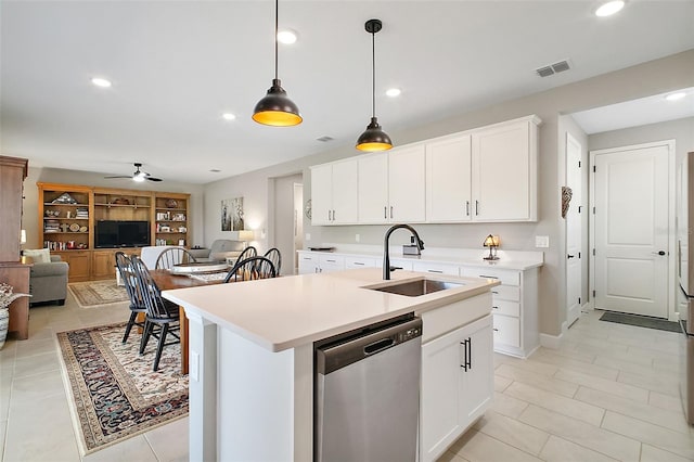 kitchen featuring visible vents, open floor plan, light countertops, stainless steel dishwasher, and a sink