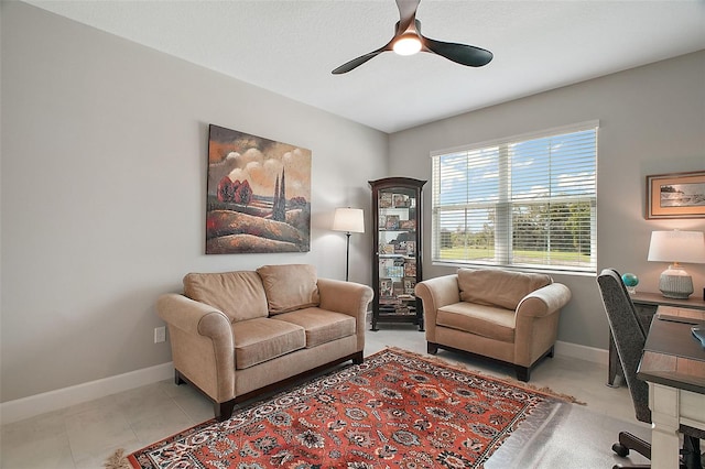 office space with a ceiling fan, tile patterned flooring, and baseboards