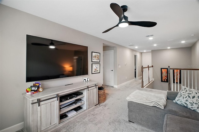 living room with light carpet, baseboards, visible vents, and ceiling fan