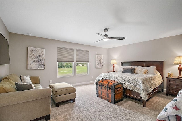 carpeted bedroom featuring ceiling fan and baseboards