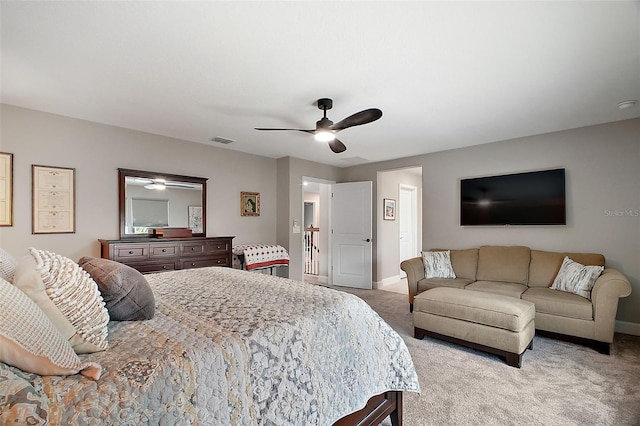 bedroom featuring light carpet, ceiling fan, visible vents, and baseboards