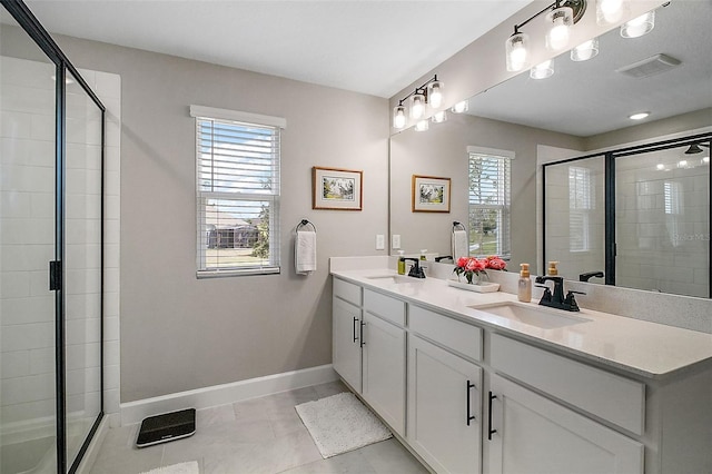 full bath with visible vents, a sink, a shower stall, and baseboards