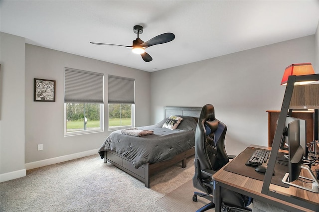 carpeted bedroom featuring ceiling fan and baseboards