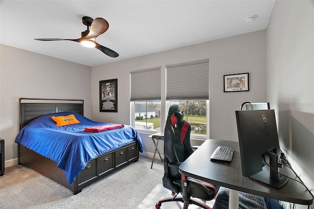 bedroom featuring a ceiling fan, light carpet, and baseboards