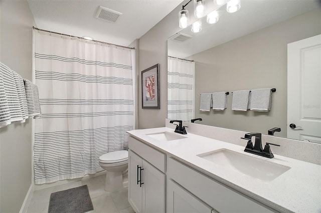 bathroom featuring toilet, visible vents, and a sink