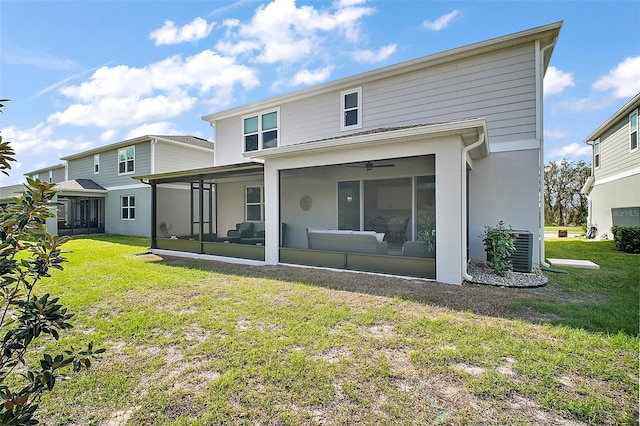 rear view of house featuring a lawn, cooling unit, and a sunroom