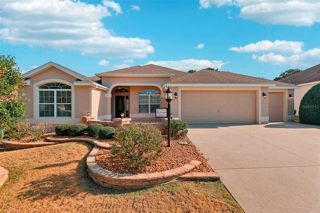 ranch-style house with a garage, concrete driveway, and stucco siding