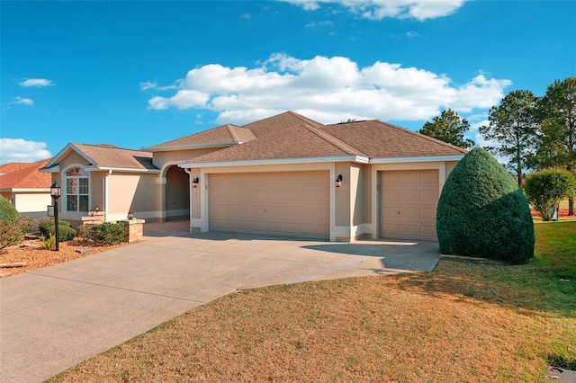 ranch-style home with a garage, a shingled roof, driveway, stucco siding, and a front yard