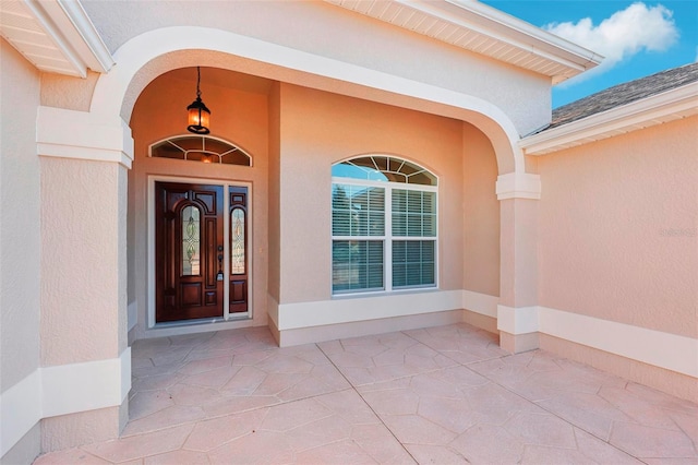 property entrance with stucco siding