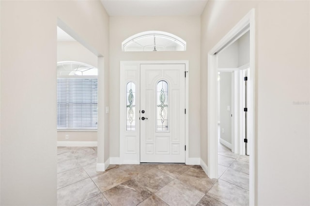 foyer entrance featuring baseboards