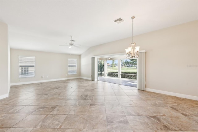 empty room featuring ceiling fan with notable chandelier, light tile patterned floors, plenty of natural light, and baseboards