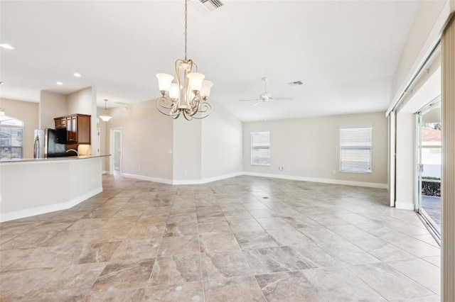 unfurnished living room with baseboards, visible vents, and a healthy amount of sunlight