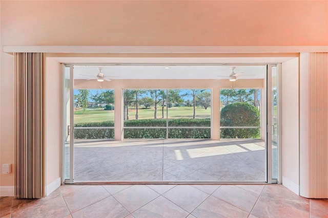 entryway with baseboards, tile patterned floors, and a healthy amount of sunlight