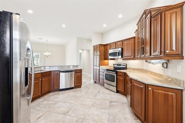 kitchen with appliances with stainless steel finishes, recessed lighting, light stone countertops, and brown cabinets