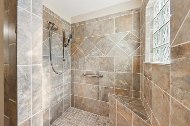 bathroom with tiled shower