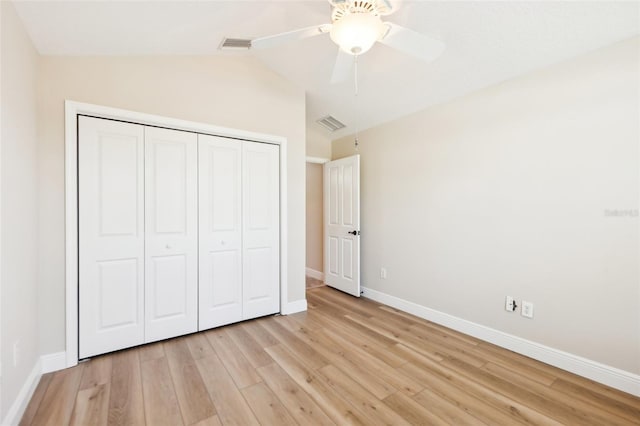 unfurnished bedroom with a closet, visible vents, light wood-style flooring, and baseboards