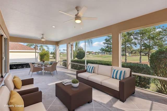 sunroom featuring a ceiling fan