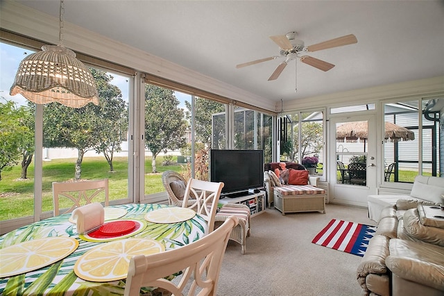 sunroom featuring ceiling fan